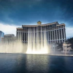 A panoramic view of the Bellagio Fountains in Las Vegas at dusk.